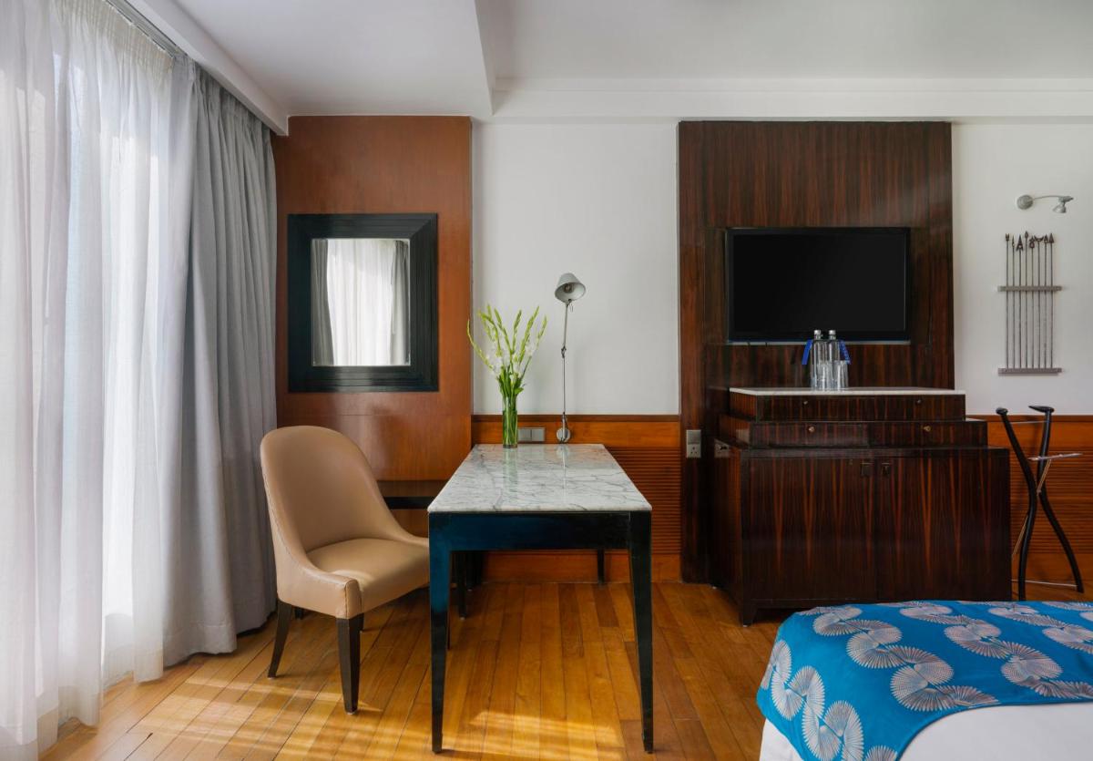 a hotel room with a table and a television at InterContinental Marine Drive Mumbai by IHG in Mumbai