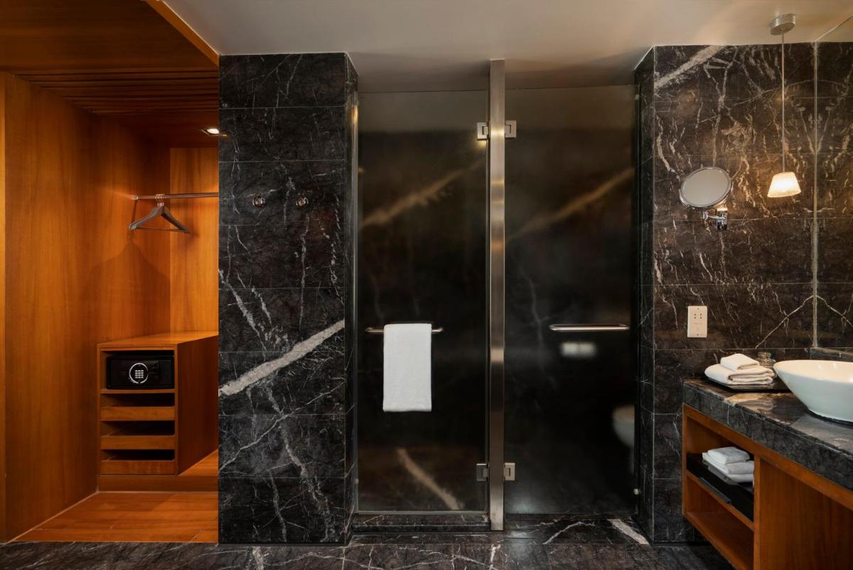 a bathroom with a shower and a sink at InterContinental Marine Drive Mumbai by IHG in Mumbai