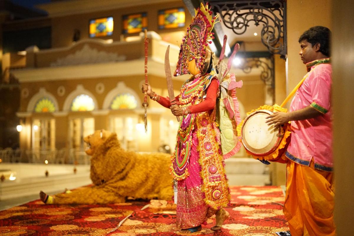 a couple of men playing drums with a lion at Raajkutir - IHCL SeleQtions in Kolkata +56 photos