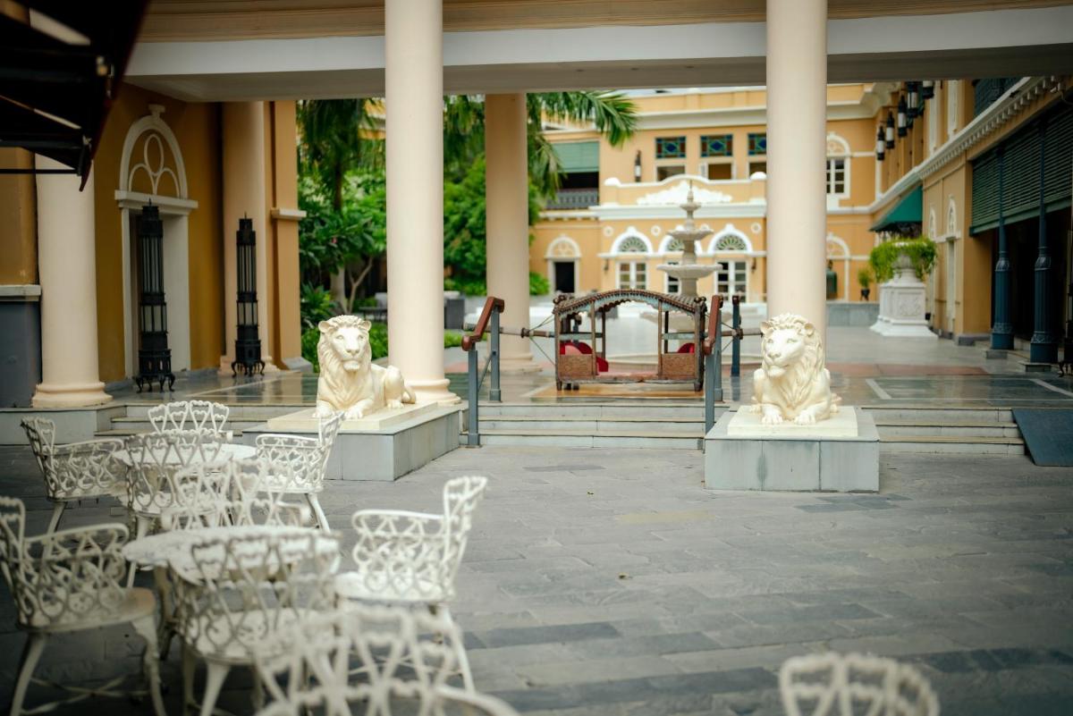 a patio with white chairs and tables in a building at Raajkutir - IHCL SeleQtions in Kolkata