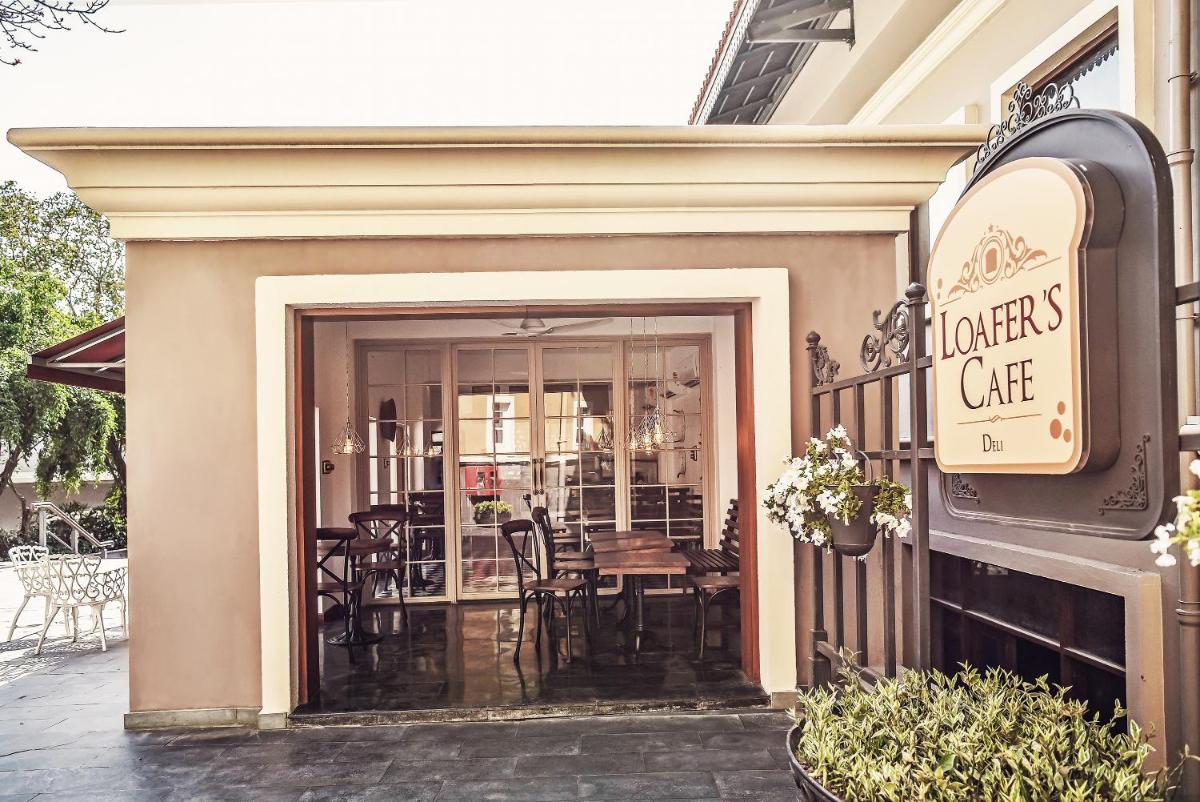 an entrance to a restaurant with a table and chairs at Raajkutir - IHCL SeleQtions in Kolkata