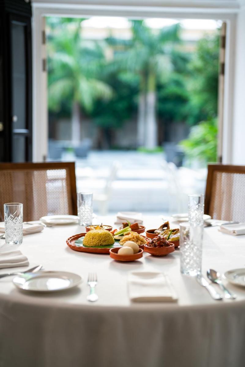 a white table with plates of food on it at Raajkutir - IHCL SeleQtions in Kolkata