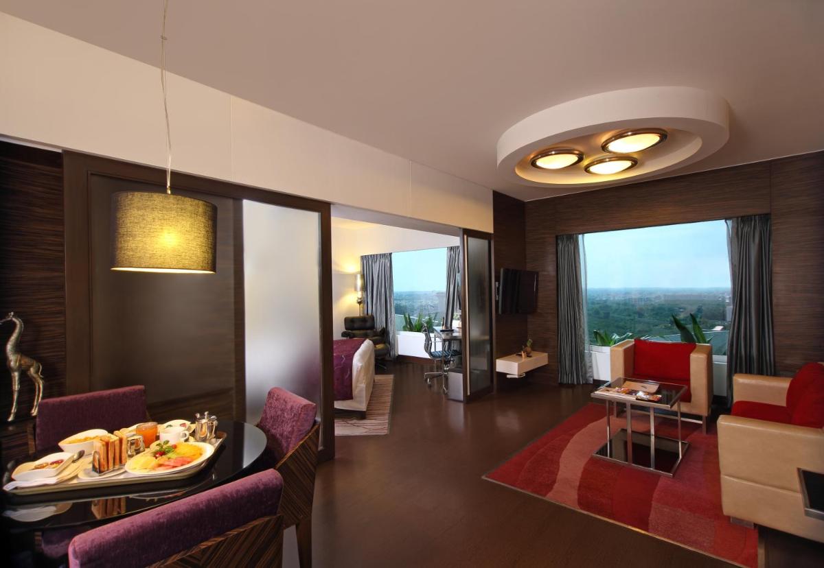 a hotel room with a table with food on it at Fortune Select SG Highway, Ahmedabad - Member ITC Hotels' Group in Ahmedabad
