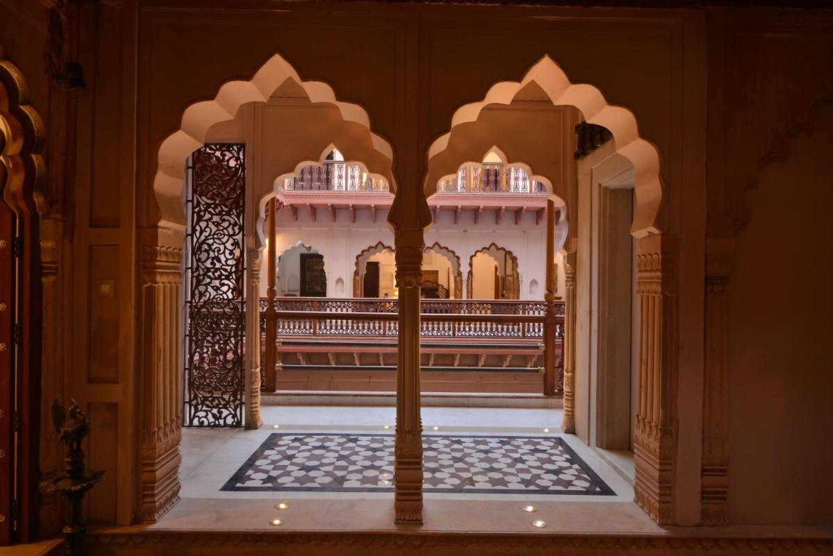 an entrance to a palace with a gate and a building at Haveli Dharampura & Golden Haveli- UNESCO awarded Boutique Heritage Hotel in New Delhi an entrance to a palace with a gate and a building at Haveli Dharampura & Golden Haveli- UNESCO awarded Boutique Heritage Hotel in New Delhi