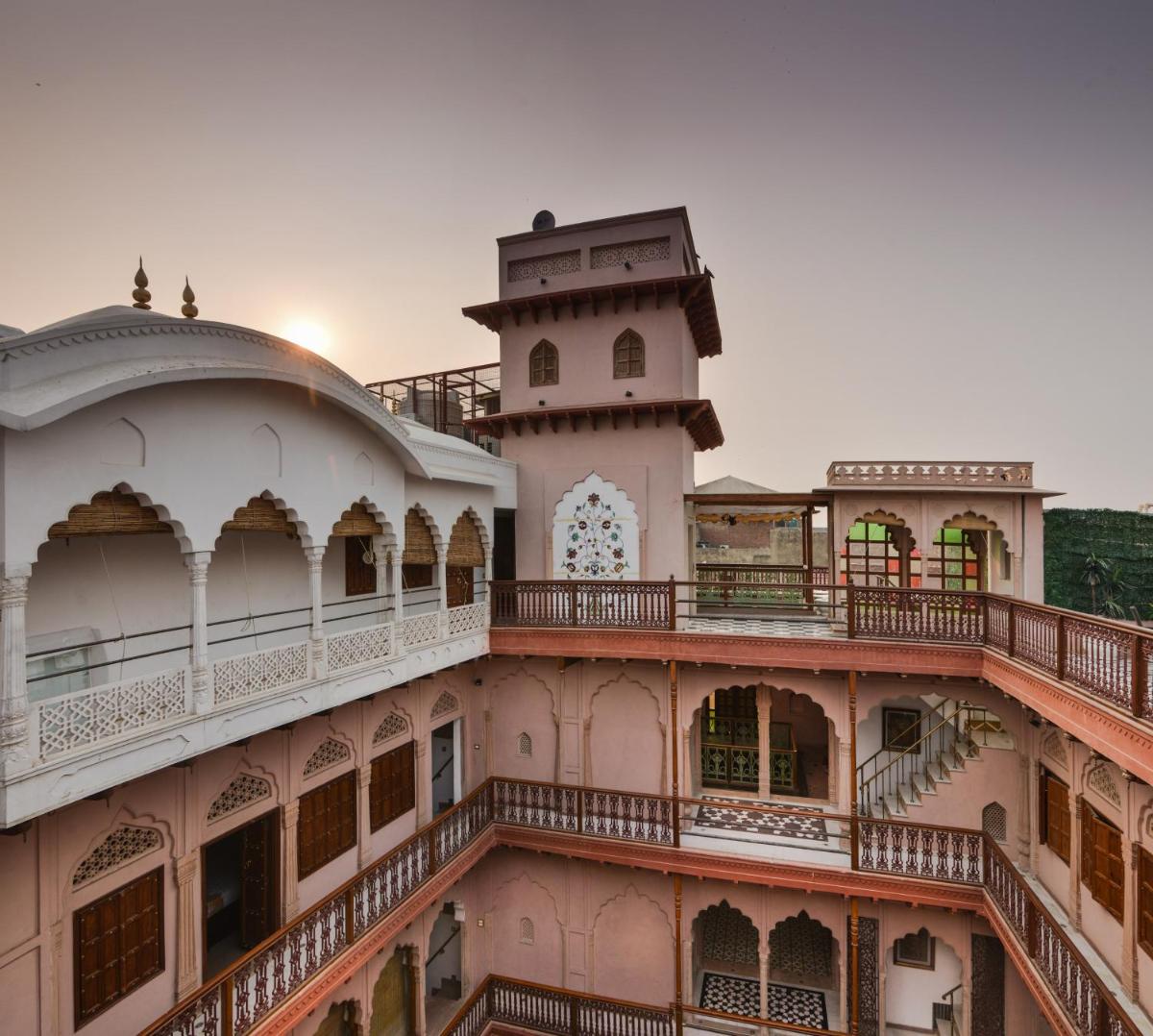 a building with a clock tower on top of it at Haveli Dharampura & Golden Haveli- UNESCO awarded Boutique Heritage Hotel in New Delhi a building with a clock tower on top of it at Haveli Dharampura & Golden Haveli- UNESCO awarded Boutique Heritage Hotel in New Delhi