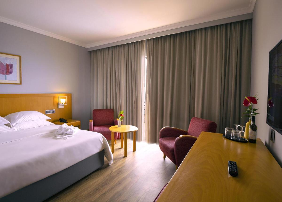 Uma cama ou camas num quarto em Madeira Panorâmico Hotel
