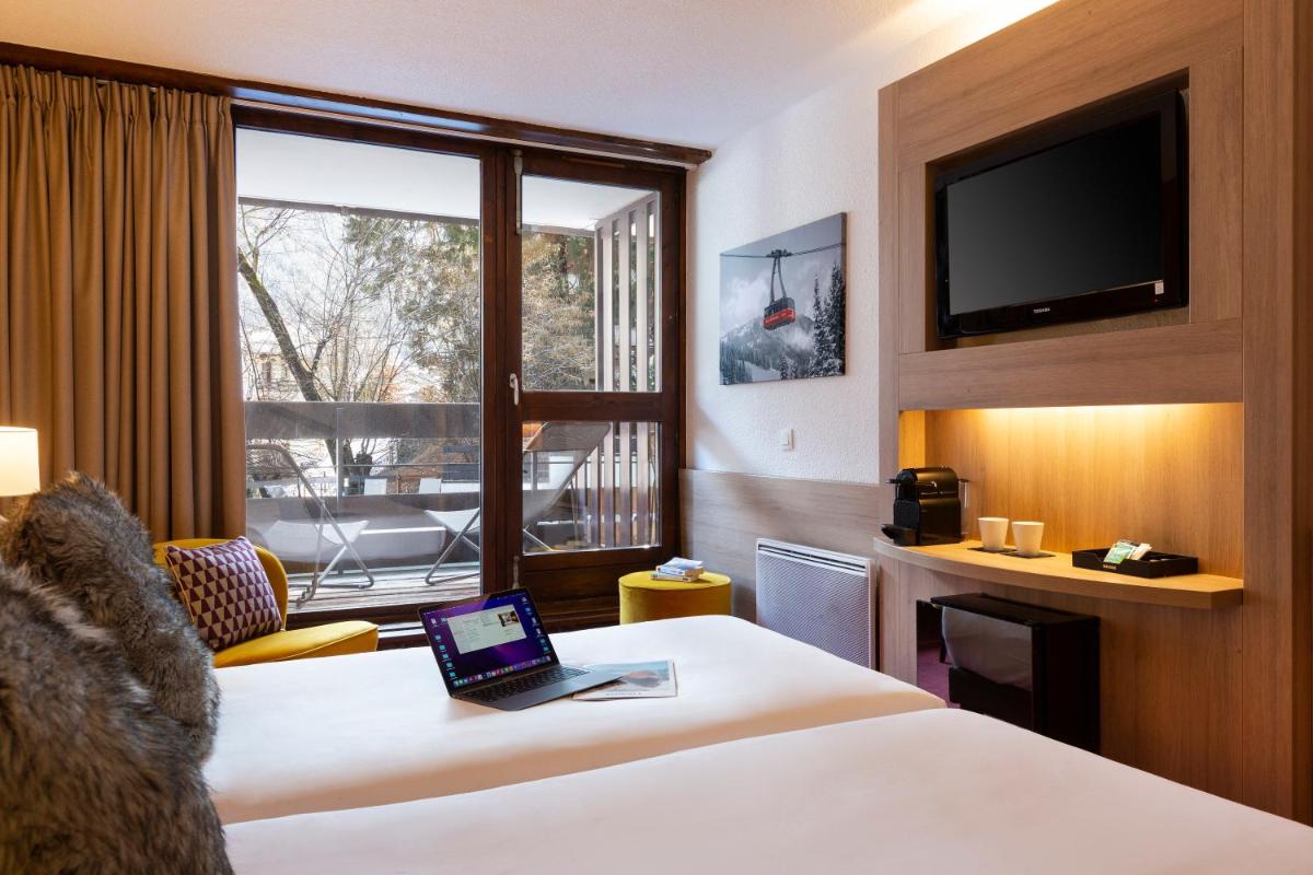 Un ou plusieurs lits dans un hébergement de l'établissement SOWELL HOTELS Mont Blanc et SPA