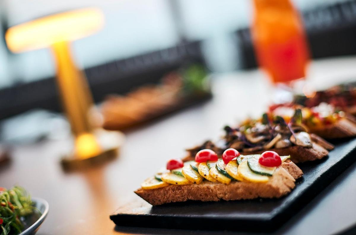 a black plate of food on a table at Hyatt Place Jaipur Malviya Nagar in Jaipur a black plate of food on a table at Hyatt Place Jaipur Malviya Nagar in Jaipur
