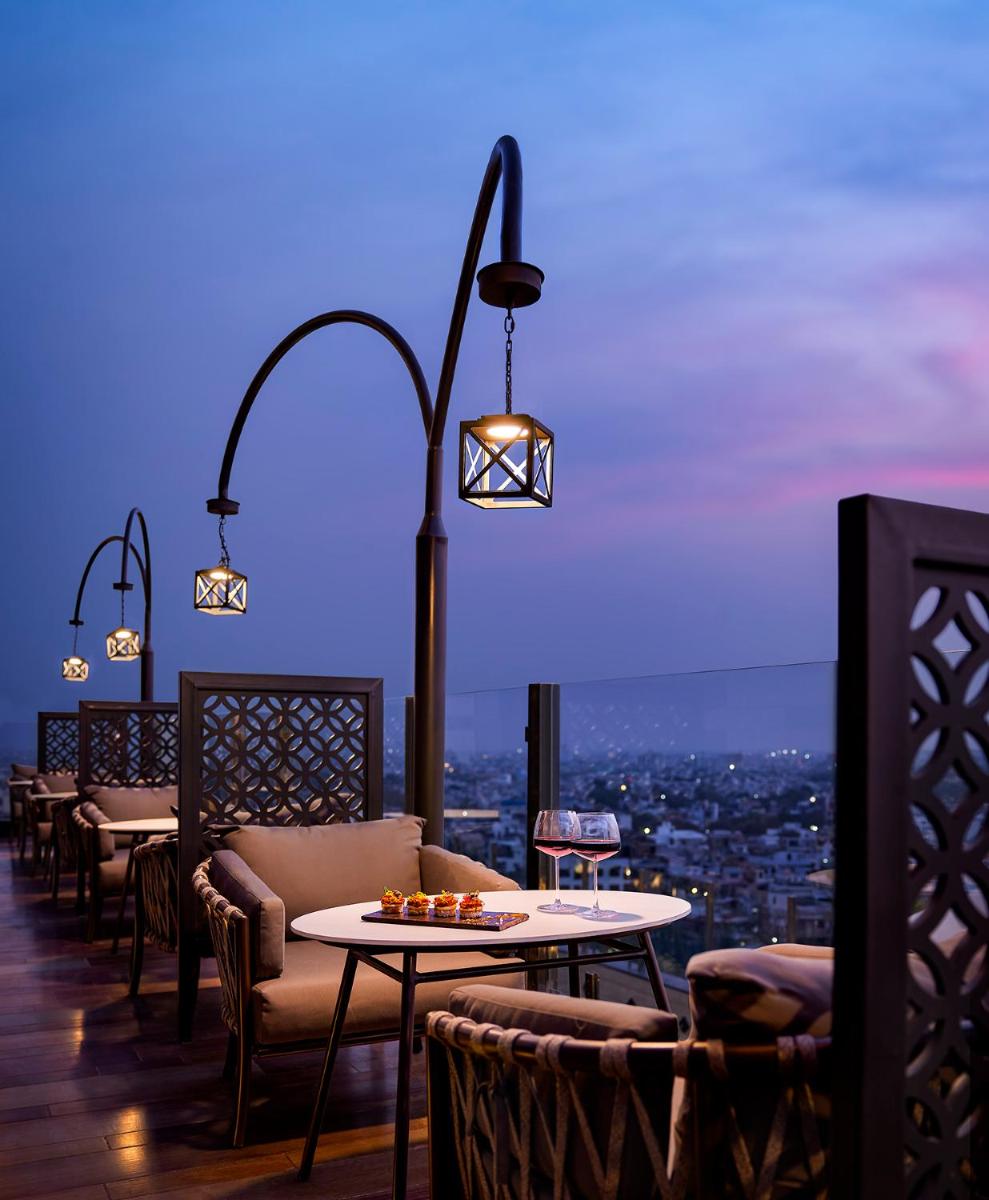 a restaurant with tables and chairs and a view at Hyatt Place Jaipur Malviya Nagar in Jaipur a restaurant with tables and chairs and a view at Hyatt Place Jaipur Malviya Nagar in Jaipur