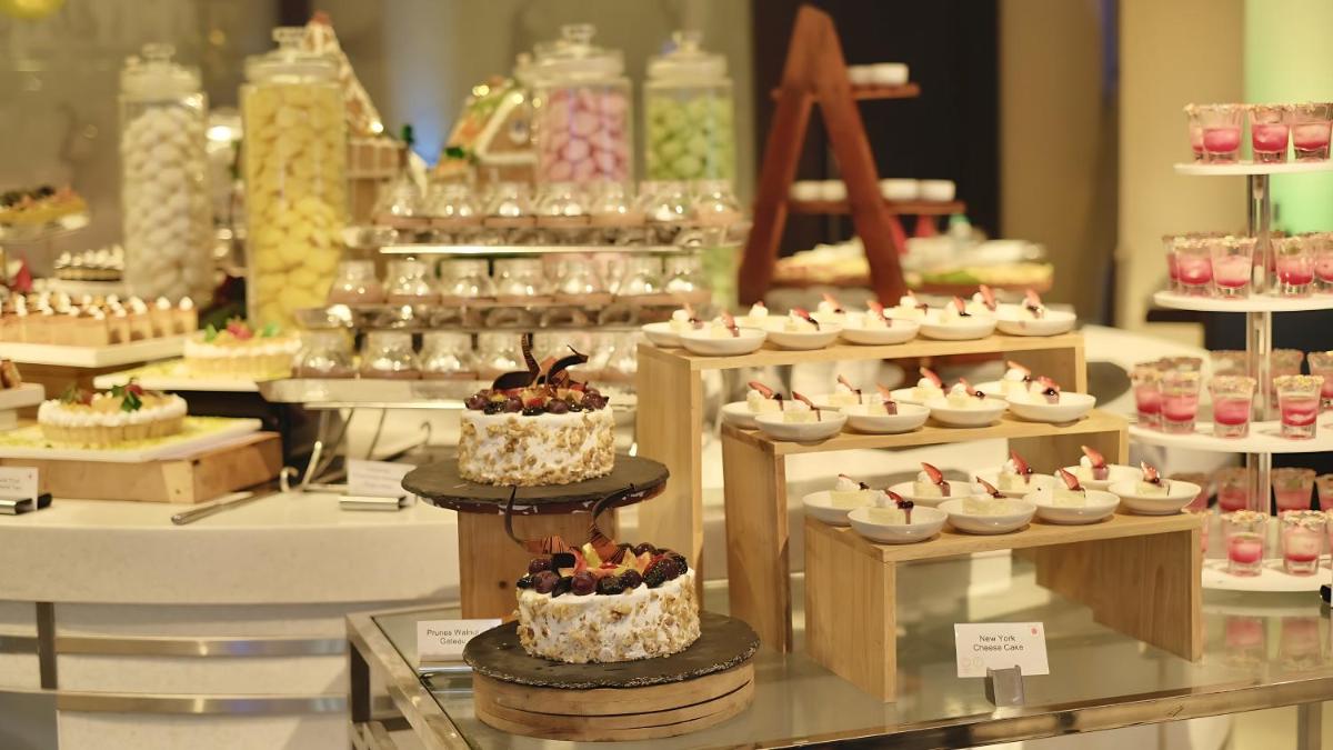 a display of cakes and pastries in a bakery at Holiday Inn Chennai OMR IT Expressway by IHG in Chennai