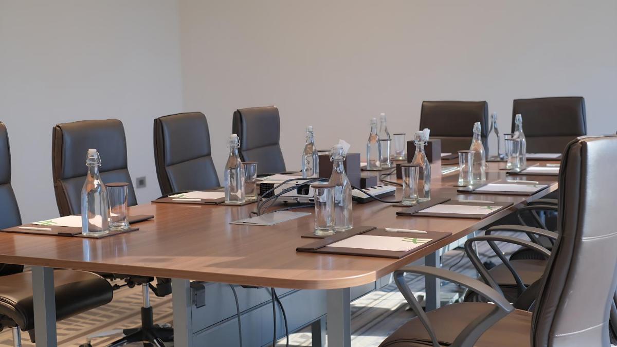 a conference room with a long wooden table and chairs at Holiday Inn Chennai OMR IT Expressway by IHG in Chennai