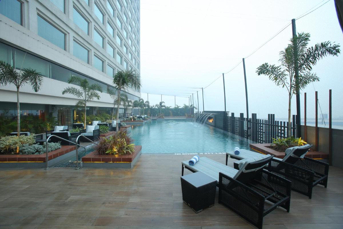 a swimming pool in the middle of a building at Crowne Plaza New Delhi Mayur Vihar Noida by IHG in New Delhi