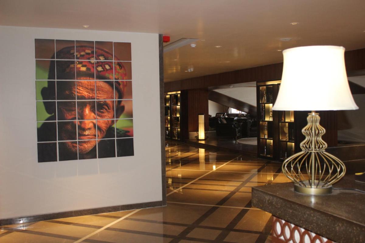 a lamp and a picture in a hotel lobby at Radisson Kufri in Shimla