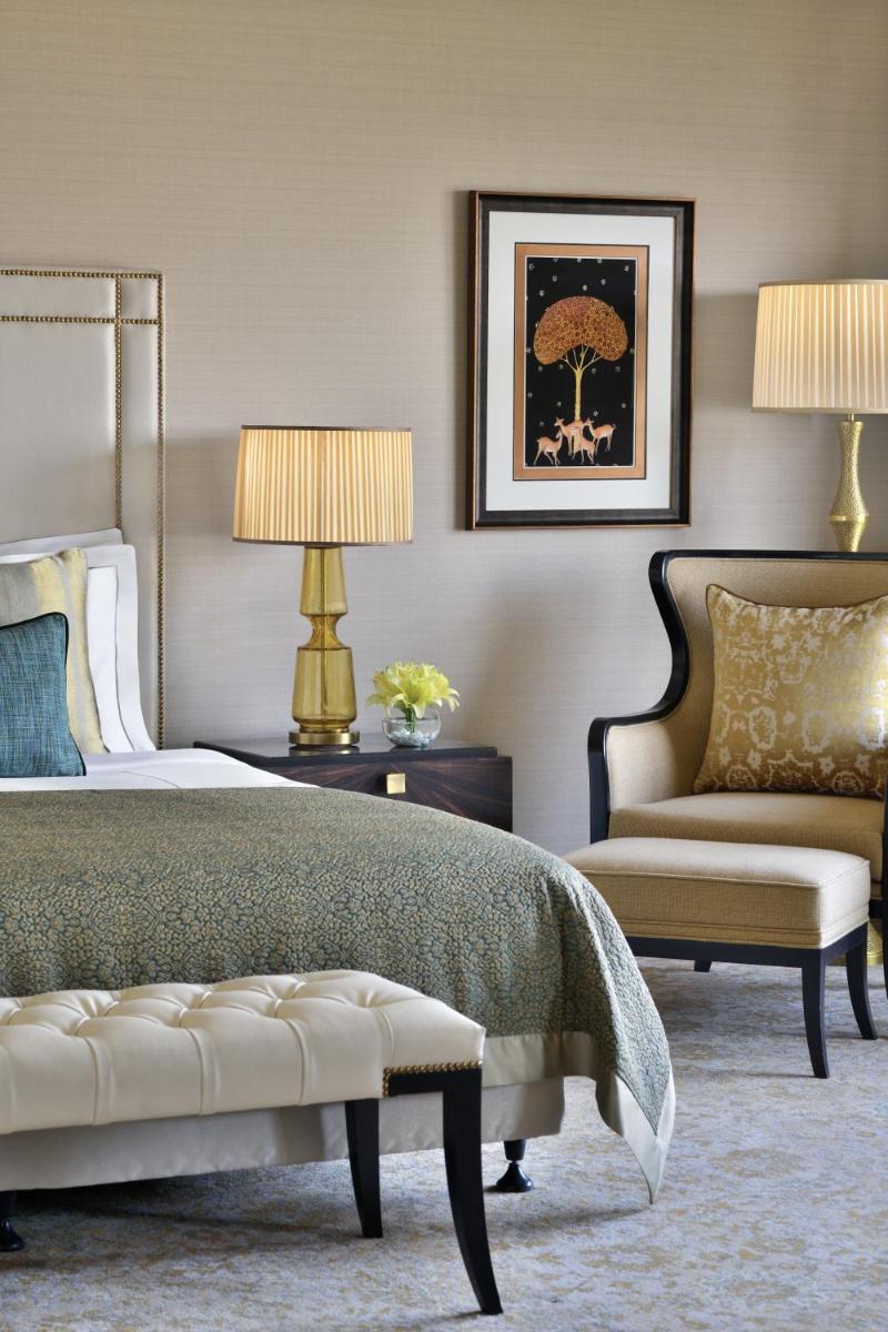 a bedroom with a bed and a couch and a chair at Taj Mahal, New Delhi in New Delhi