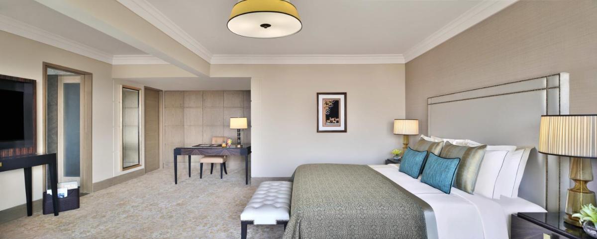 a hotel room with a bed and a desk at Taj Mahal, New Delhi in New Delhi