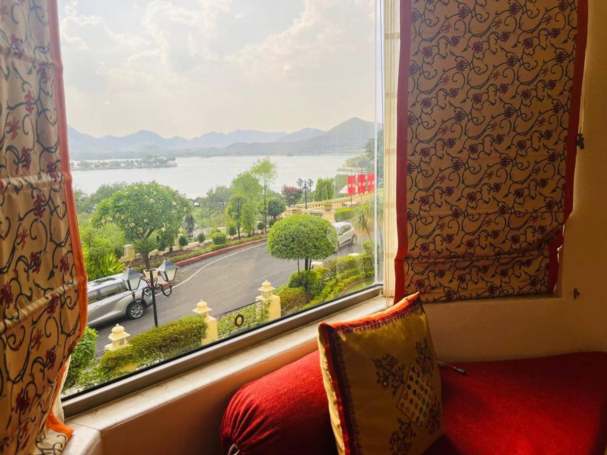 a window with a view of the water from a room at The Lalit Laxmi Vilas Palace in Udaipur