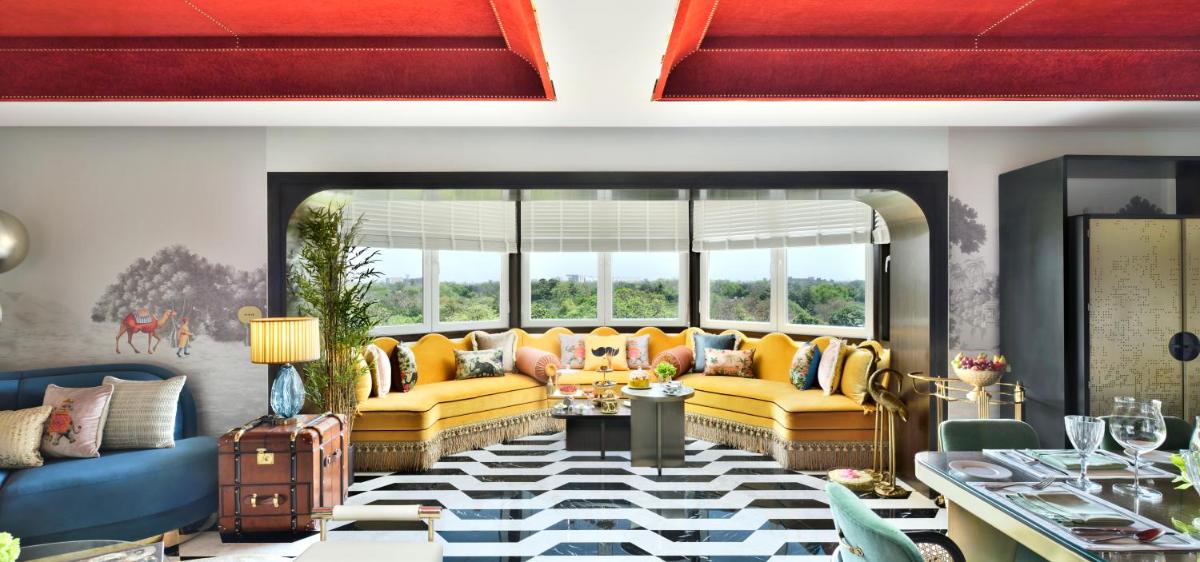 a living room with yellow couches and a table at Taj Mahal, New Delhi in New Delhi