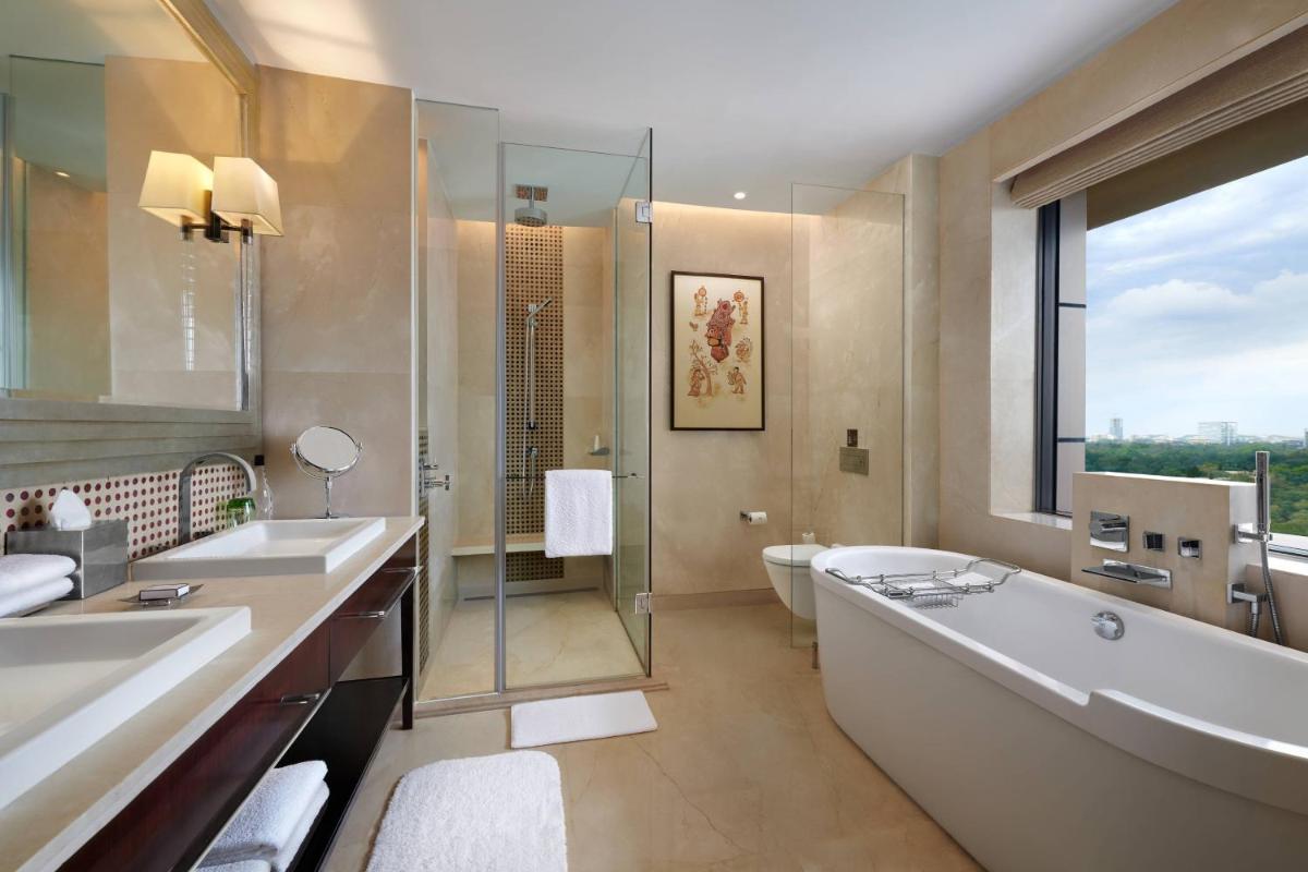 a bathroom with a tub and two sinks and a shower at JW Marriott Hotel Bengaluru in Bengaluru