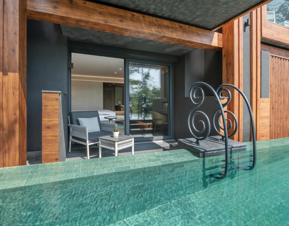 a house with a swimming pool and a patio at JW Marriott Goa in Vagator a house with a swimming pool and a patio at JW Marriott Goa in Vagator