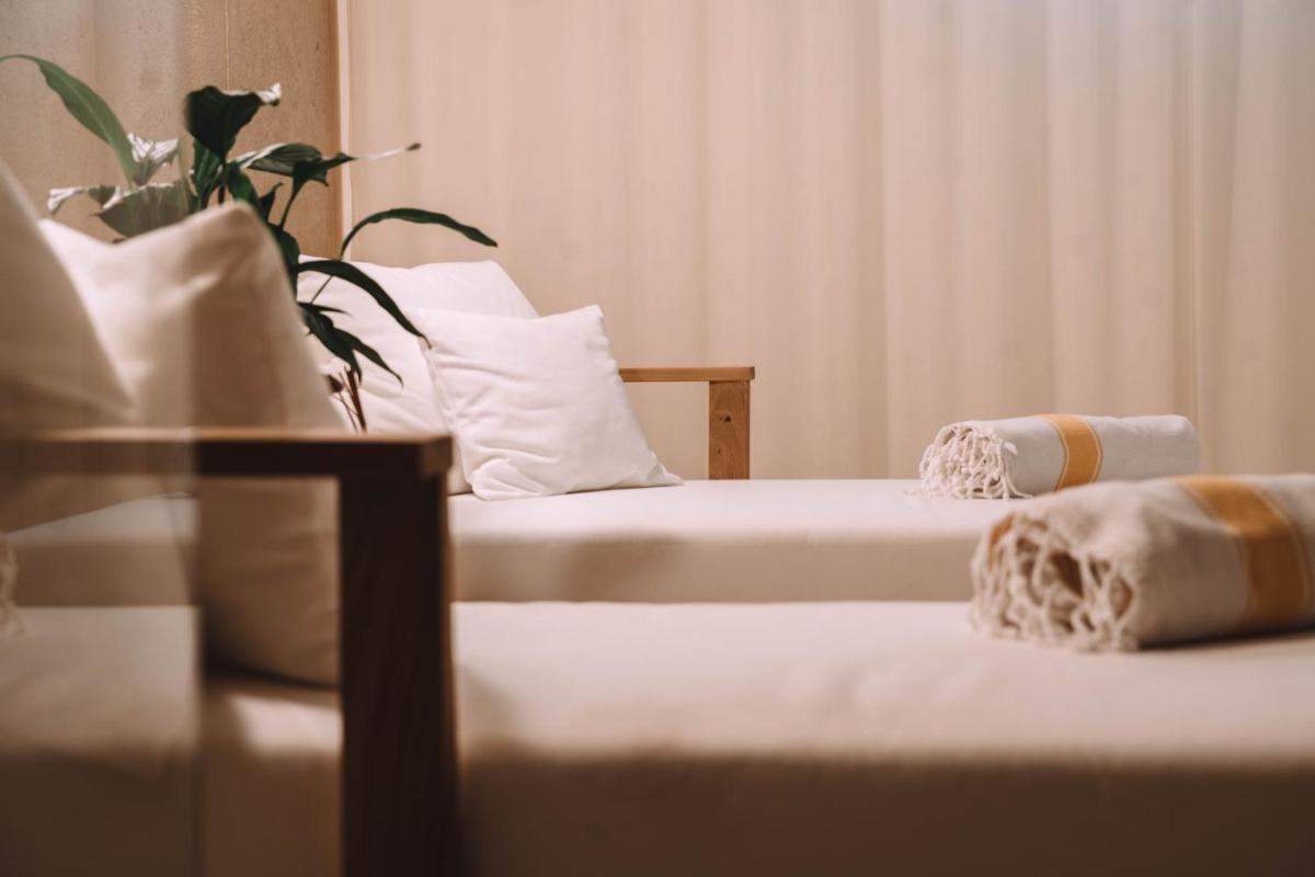 Un ou plusieurs lits dans un hébergement de l'établissement Hôtel Hemen