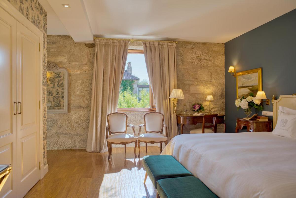 Cama o camas de una habitación en A Quinta Da Auga Hotel Spa Relais & Chateaux