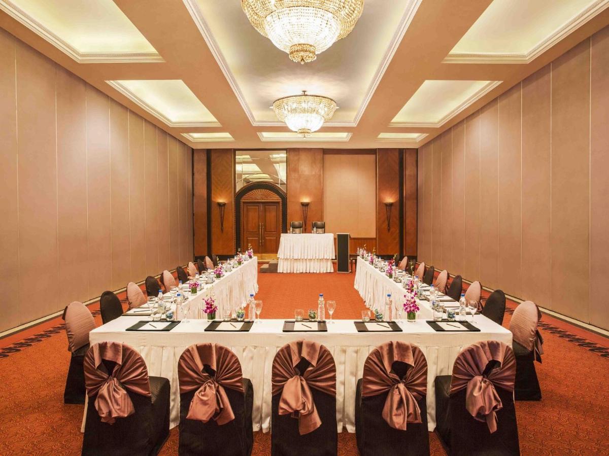 a large banquet room with tables and chairs in it at Eros Hotel New Delhi, Nehru Place in New Delhi a large banquet room with tables and chairs in it at Eros Hotel New Delhi, Nehru Place in New Delhi