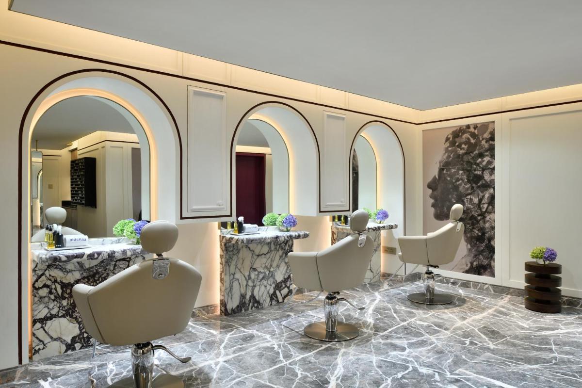 a salon with four chairs and a mirror at Taj Mahal, New Delhi in New Delhi