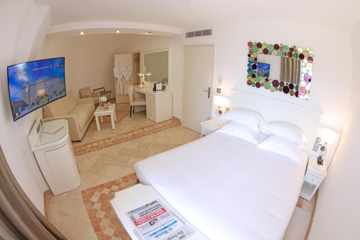 Un ou plusieurs lits dans un hébergement de l'établissement Hôtel L'Abbaye