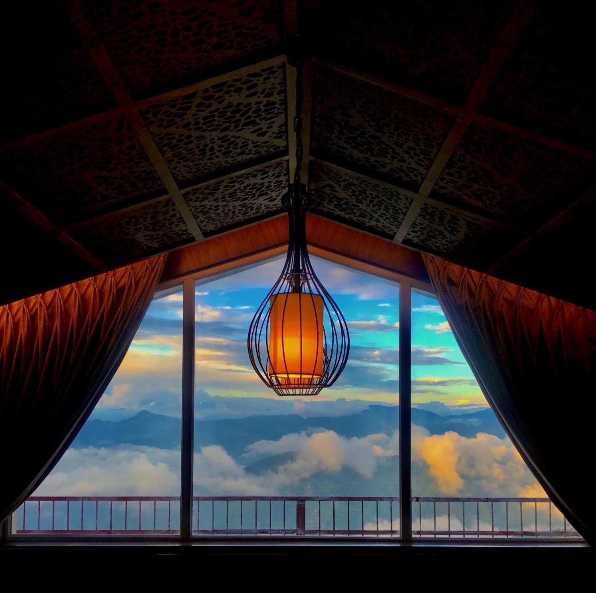 a light hanging from a window with a view at Radisson Kufri in Shimla