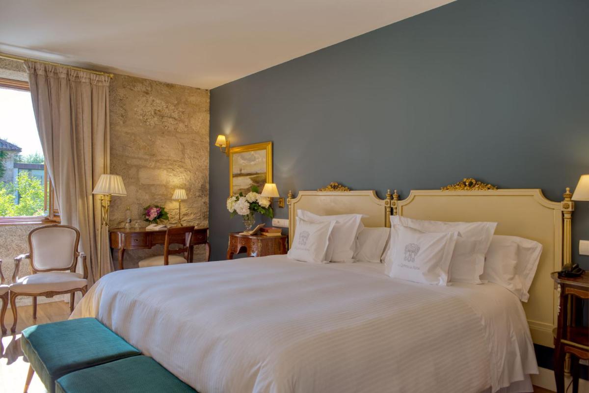 Cama o camas de una habitación en A Quinta Da Auga Hotel Spa Relais & Chateaux