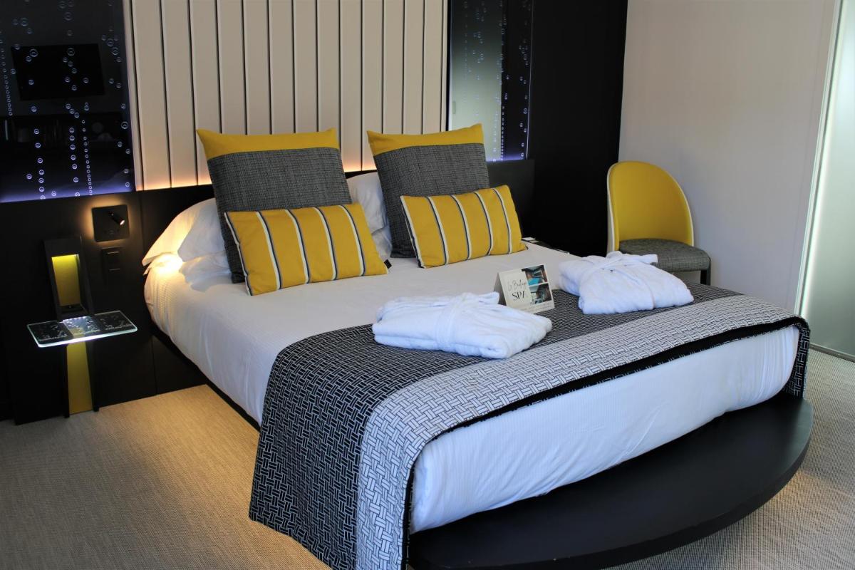 Un ou plusieurs lits dans un hébergement de l'établissement Le Bailliage Hôtel & Spa