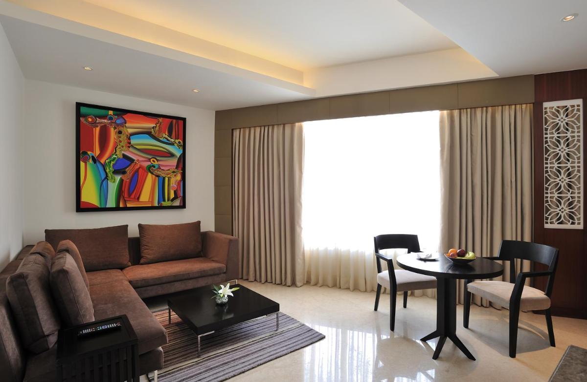 a living room with a couch and a table at The Anya Hotel-Golf Course Road in Gurgaon