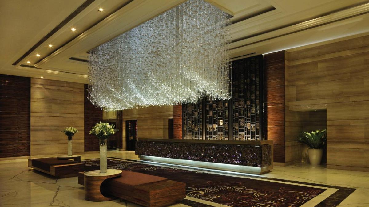 a lobby with a large chandelier in a building at Crowne Plaza New Delhi Mayur Vihar Noida by IHG in New Delhi