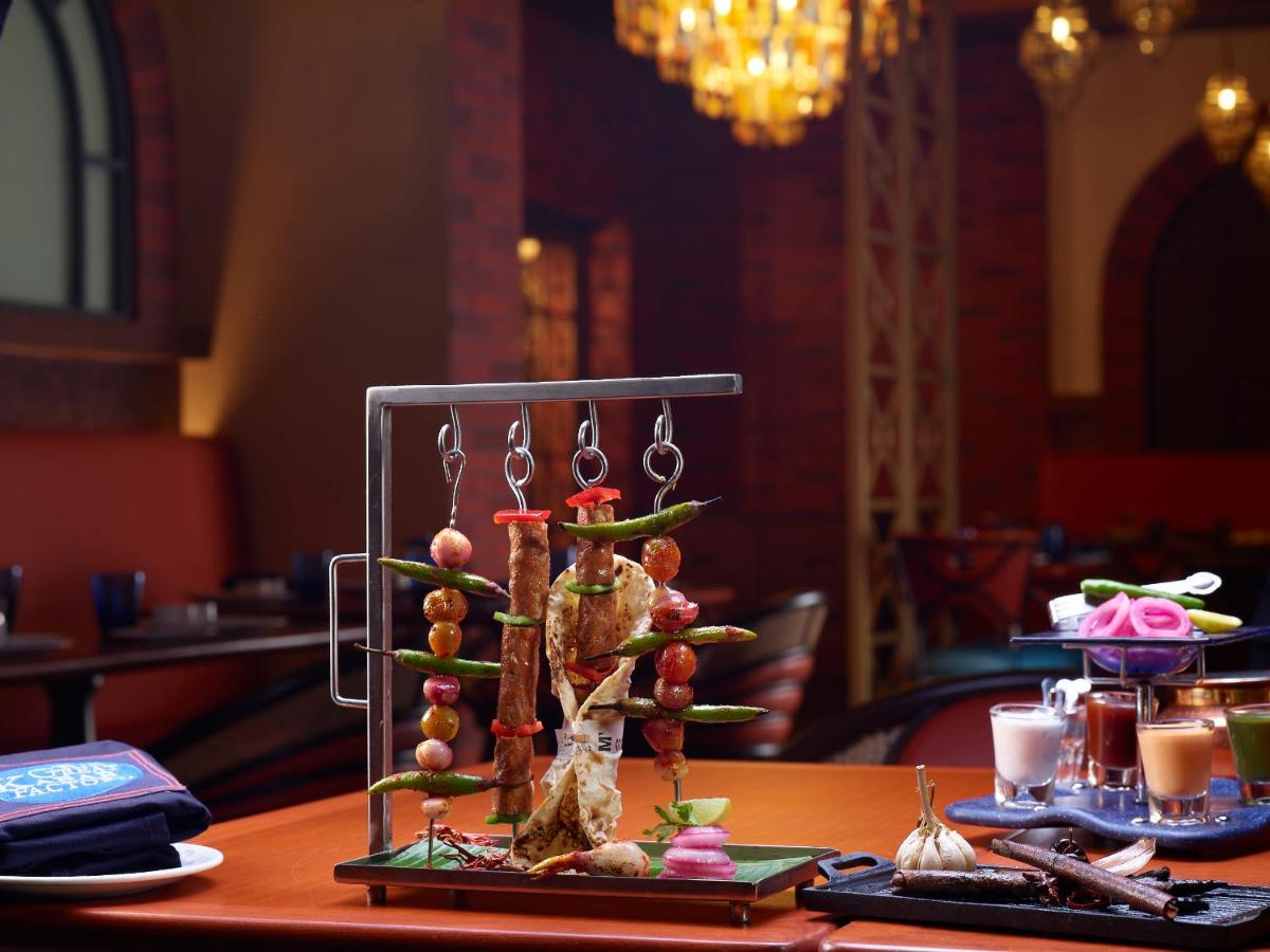 a rack of food on top of a table at Radisson Blu Hotel & Suites GRT Chennai in Chennai