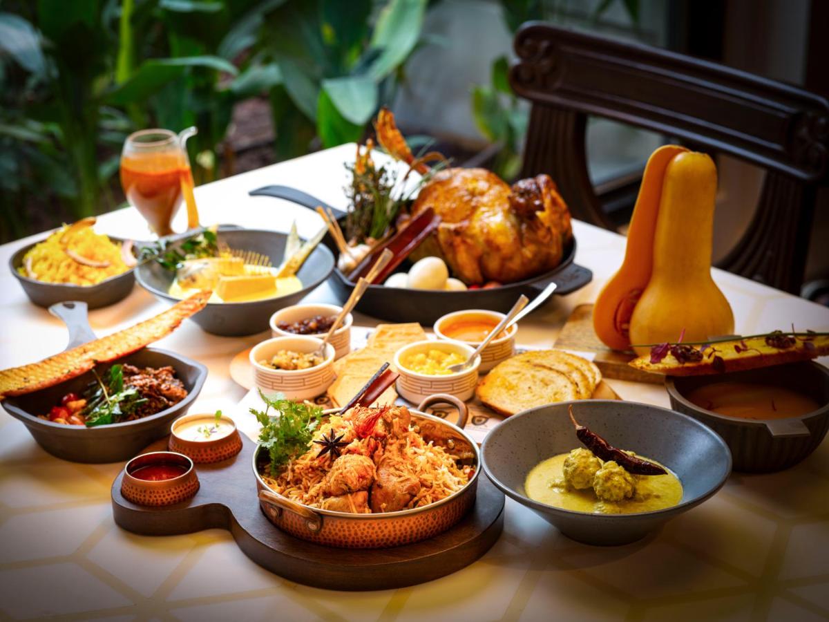 a table with many different dishes of food on it at Radisson Blu Hotel & Suites GRT Chennai in Chennai