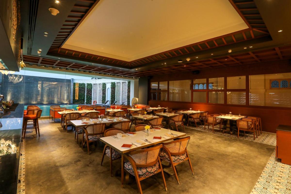 an empty dining room with tables and chairs at Radisson Blu Hotel & Suites GRT Chennai in Chennai