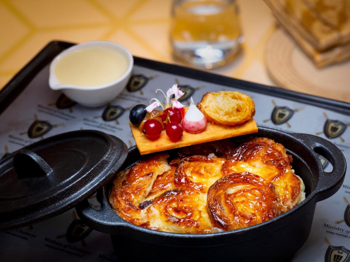 a pan of food with bread and pastries on a table at Radisson Blu Hotel & Suites GRT Chennai in Chennai