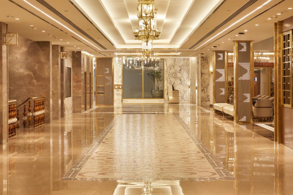 a hallway of a hotel with a chandelier at Radisson Blu Hotel & Suites GRT Chennai in Chennai