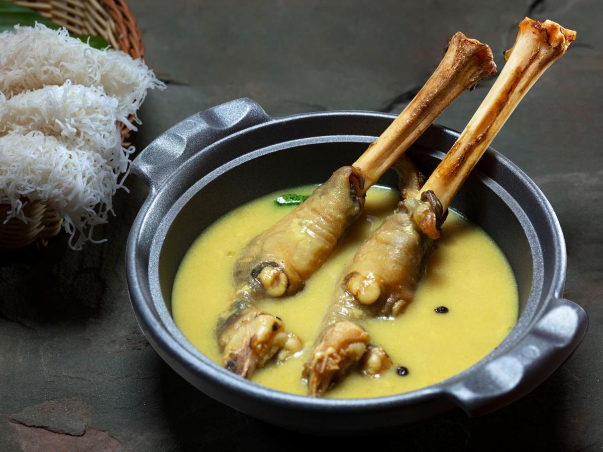 a bowl of soup with some food in it at Radisson Blu Hotel & Suites GRT Chennai in Chennai