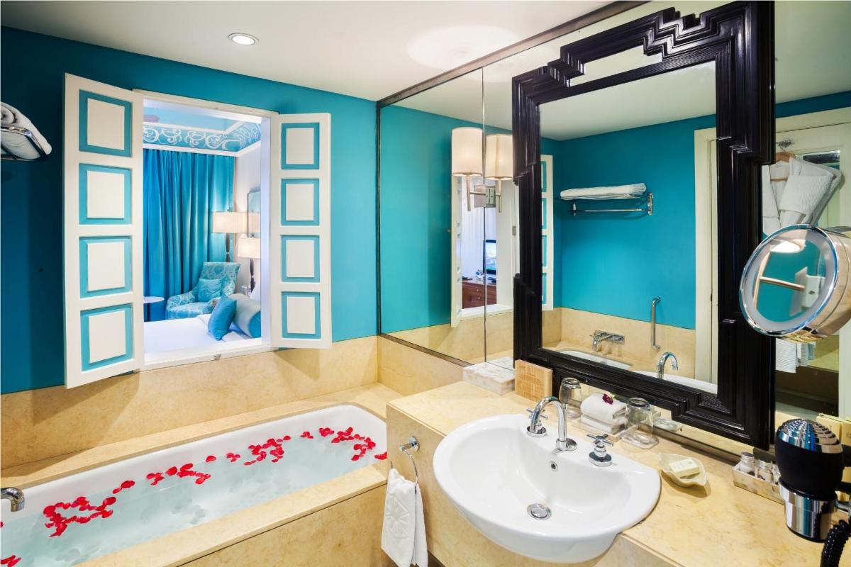 a bathroom with a tub and a sink at Jai Mahal Palace in Jaipur