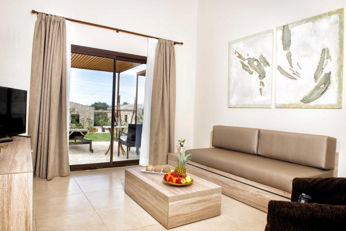 Una sala de estar con un sofá y un televisor. en Hotel Son Trobat Wellness & Spa, en Sant Llorenç des Cardassar