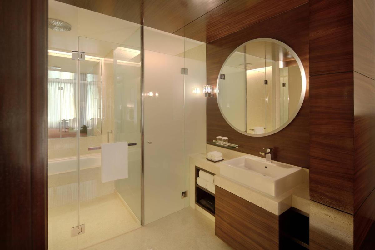 a bathroom with a sink and a mirror at JW Marriott Pune in Pune
