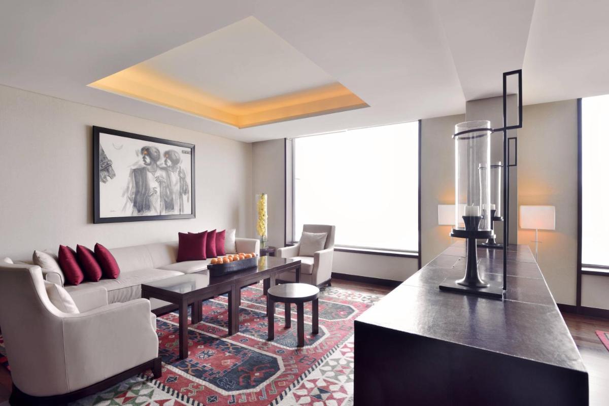 a living room with a couch and a table at JW Marriott Pune in Pune