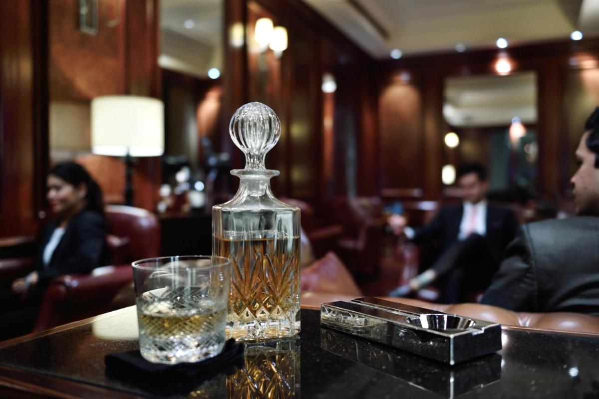 a bottle of whiskey sitting on a table with a glass at JW Marriott Pune in Pune