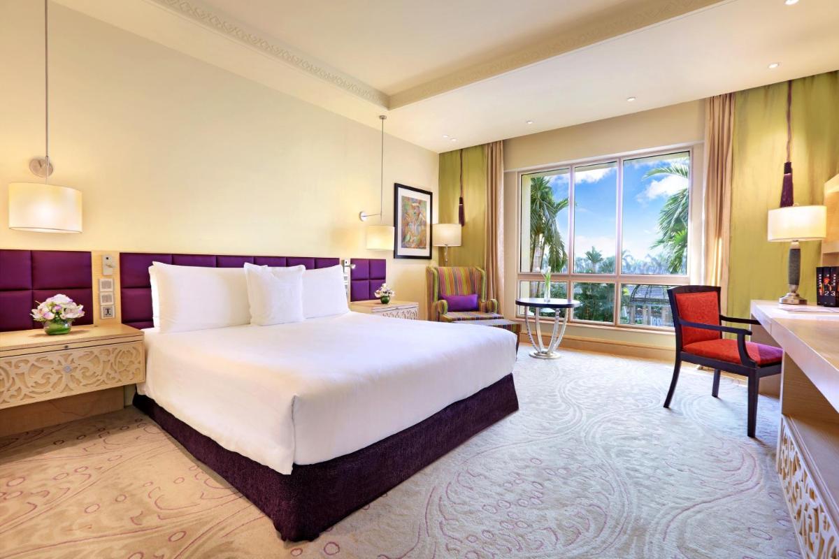 a hotel room with a large bed and a window at ITC Maratha, a Luxury Collection Hotel, Mumbai in Mumbai