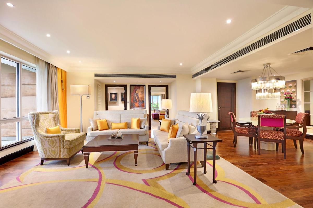 a living room with white furniture and a dining room at ITC Maratha, a Luxury Collection Hotel, Mumbai in Mumbai