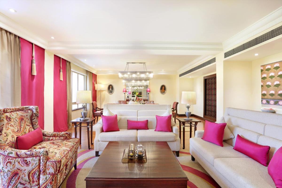 a living room with pink pillows on the furniture at ITC Maratha, a Luxury Collection Hotel, Mumbai in Mumbai