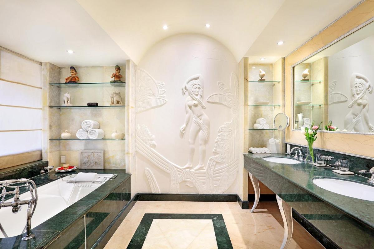 a bathroom with two sinks and two mirrors at ITC Maratha, a Luxury Collection Hotel, Mumbai in Mumbai