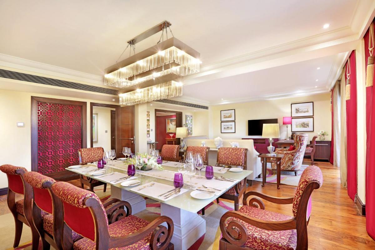 a dining room with a table and chairs at ITC Maratha, a Luxury Collection Hotel, Mumbai in Mumbai