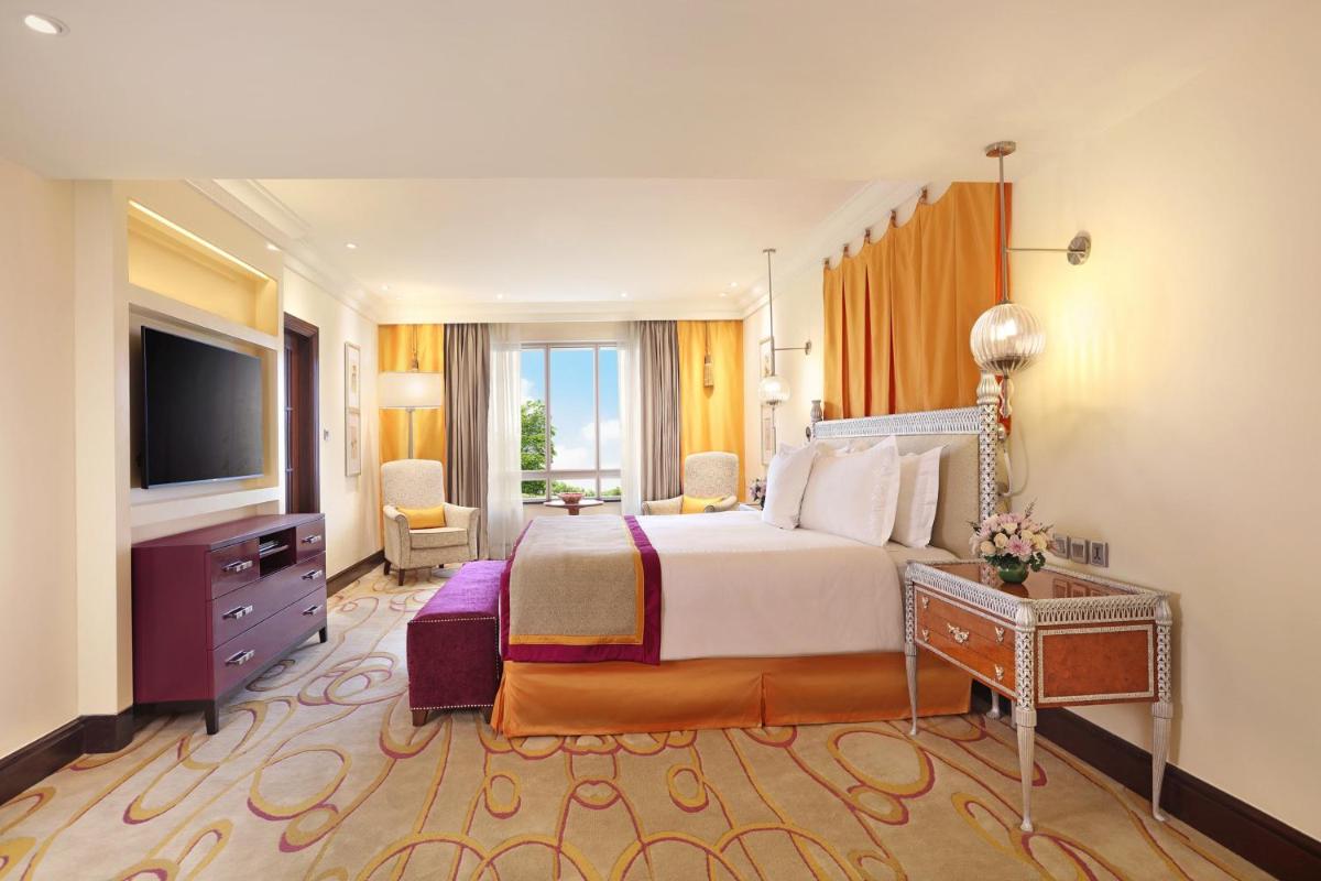 a hotel room with a bed and a television at ITC Maratha, a Luxury Collection Hotel, Mumbai in Mumbai
